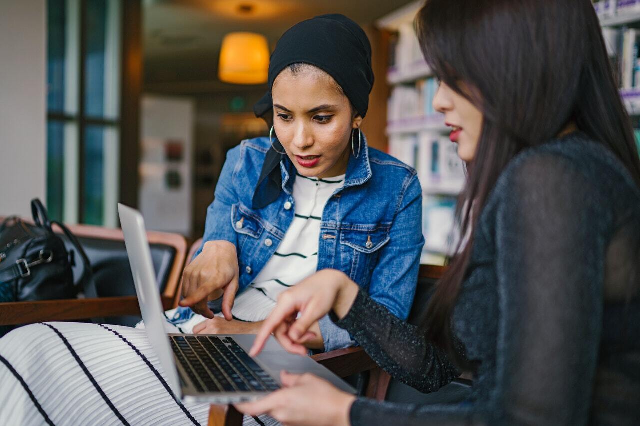 Two women looking at laptop screen